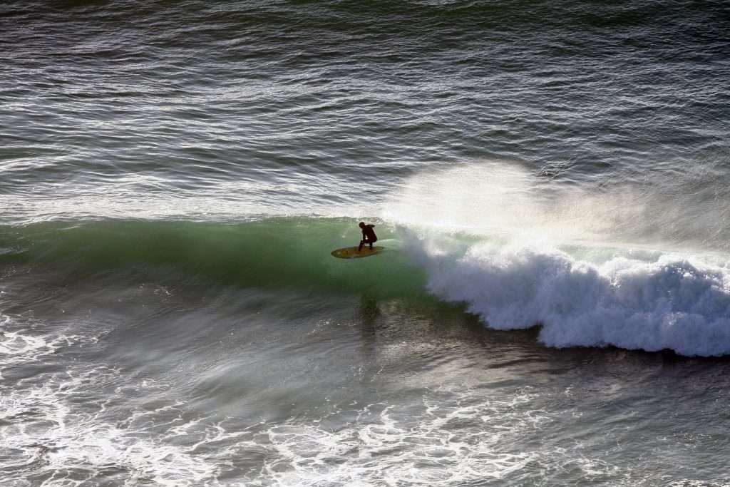 Surfer riding on an Electric Surfboard