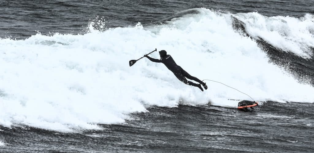 SUP Surfing Crash into a wave