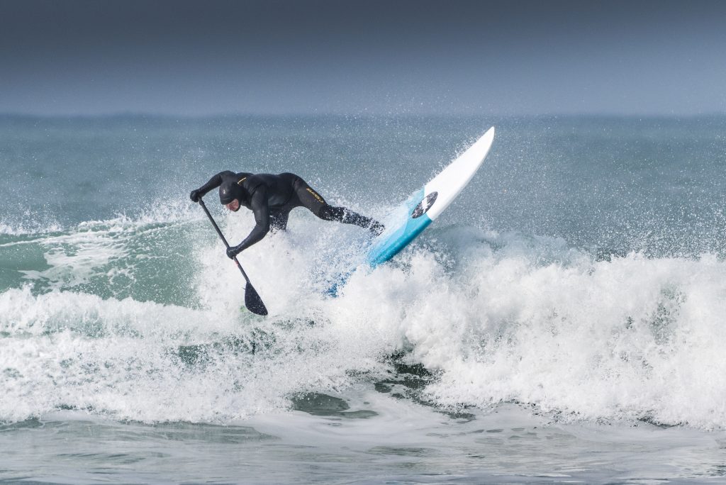 Dom Moore riding the waves on Fistral Beach in Newquay, Cornwall.