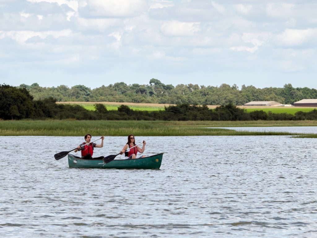 What is the difference between canoeing and kayaking