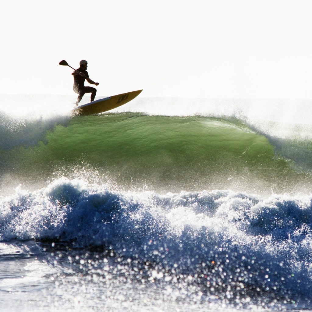 Surfer Stand Up Paddle Surfing the wave