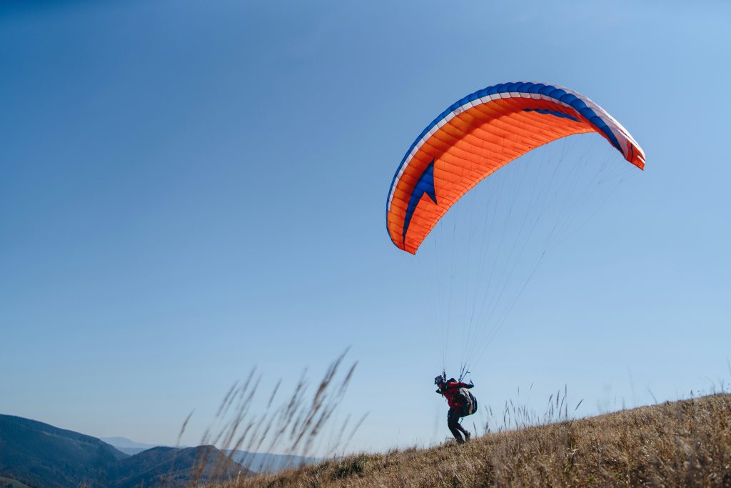 Paraglider on a hill about to take off