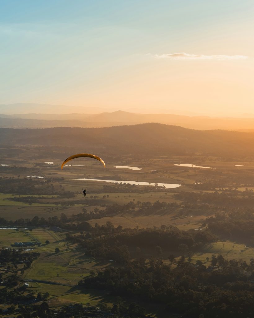 paraglider in flight scenic background