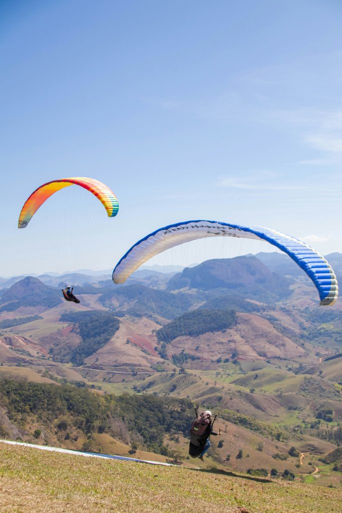 Two paragliders flying in the hills