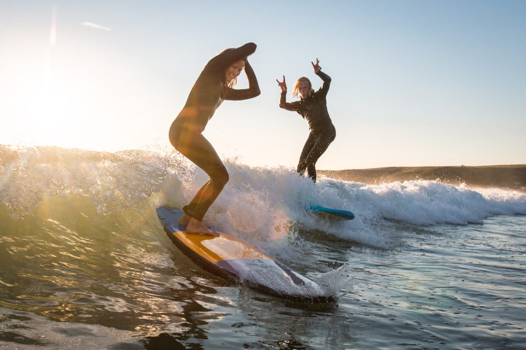 2 people surfing